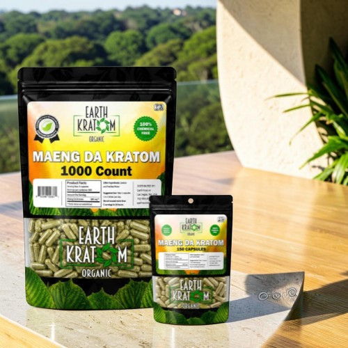Two packages of Maeng Da Kratom on a table outdoors.