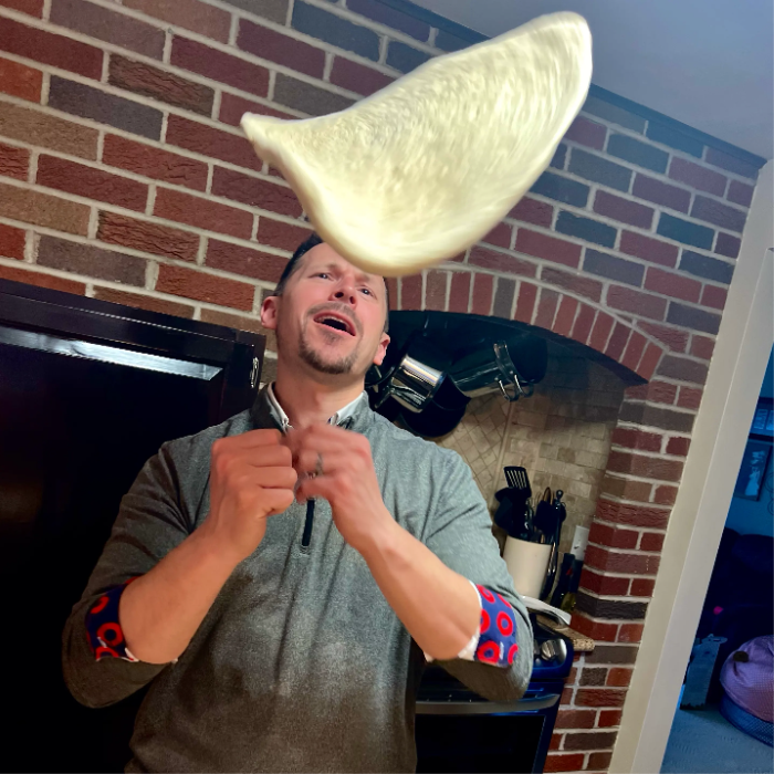 Zach spinning pizza dough