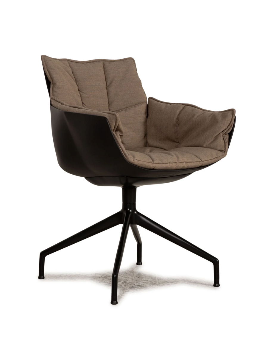 Stylish swivel B&B Italia Husk chair with a padded seat and black metal base.