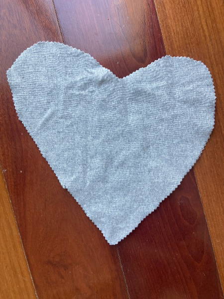 fabric heart cut out of gray jersey knit with pinking shears