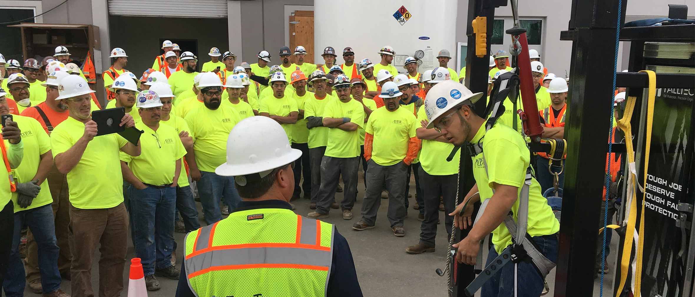 FallTech Regional Sales Manager Jim Ciandella teaching a group of construction workers the importance of trauma relief when suspended from a fall protection harness
