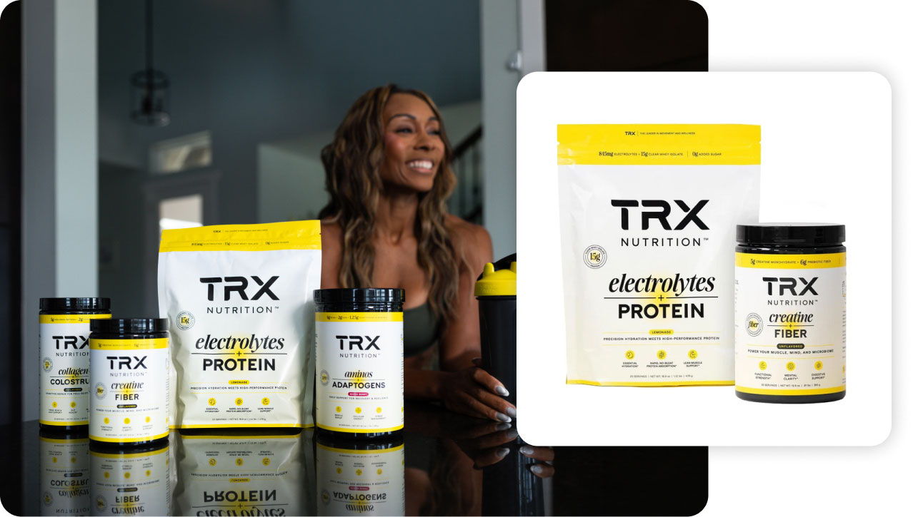 Woman smiling with TRX Nutrition products on a table.