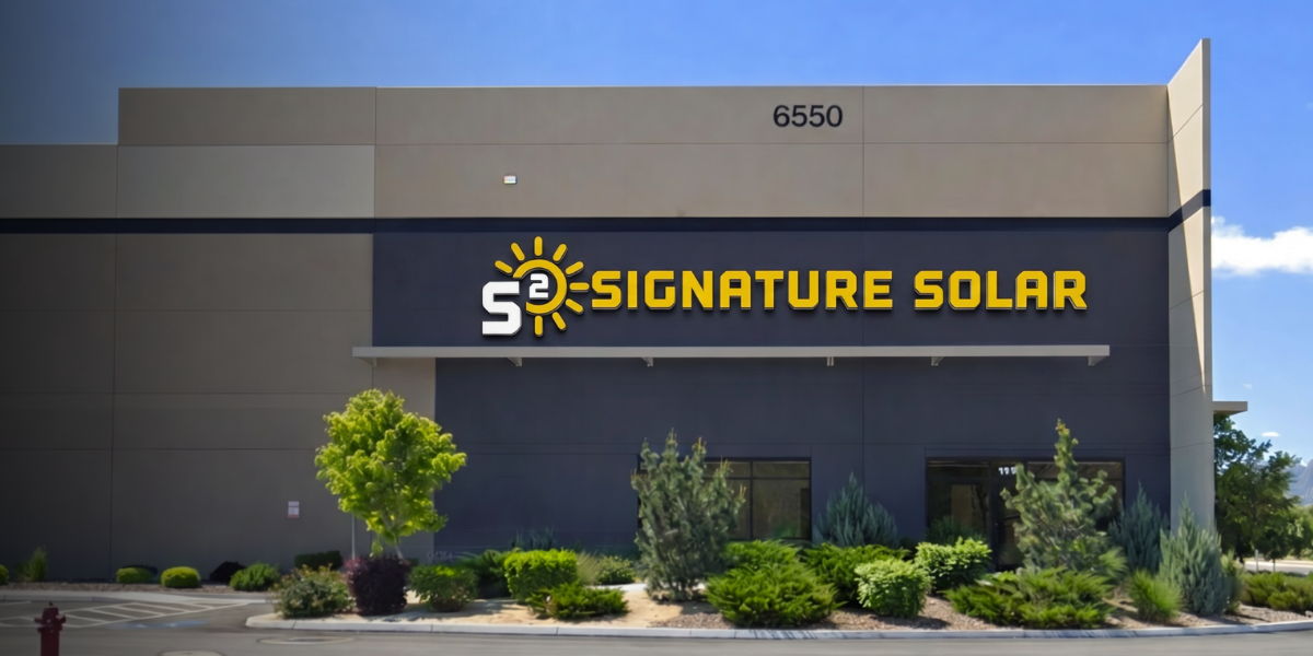 Signature Solar Reno retail store building exterior with logo sign and greenery in front.