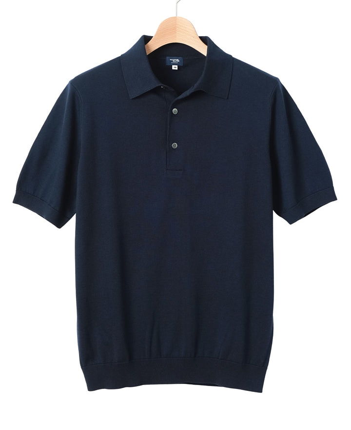 Navy blue short-sleeve polo shirt hanging on a wooden hanger.