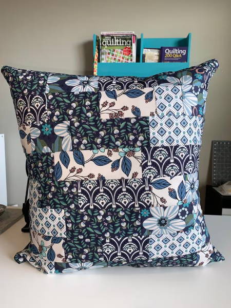 Front side of a handmade pillow cover with patchwork fabric
