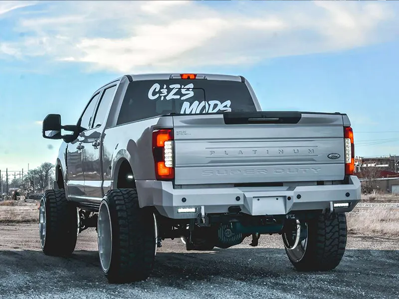 Rear view of Holden's lifted silver 2017 Ford F250 Platinum Super Duty with C&Z'S MODS decal