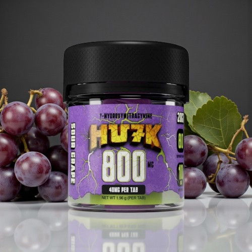 Container of HU3K 800 supplement next to fresh grapes.