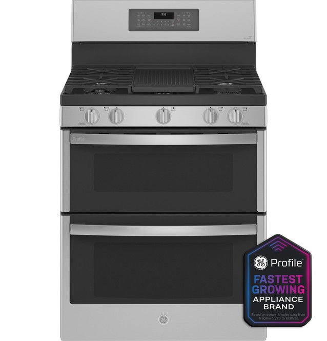 Stainless steel gas range with double oven and control knobs.