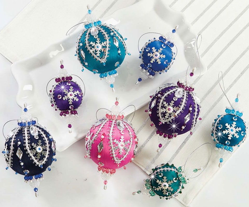 Colorful decorative ornaments in various shapes and sizes, adorned with beads.