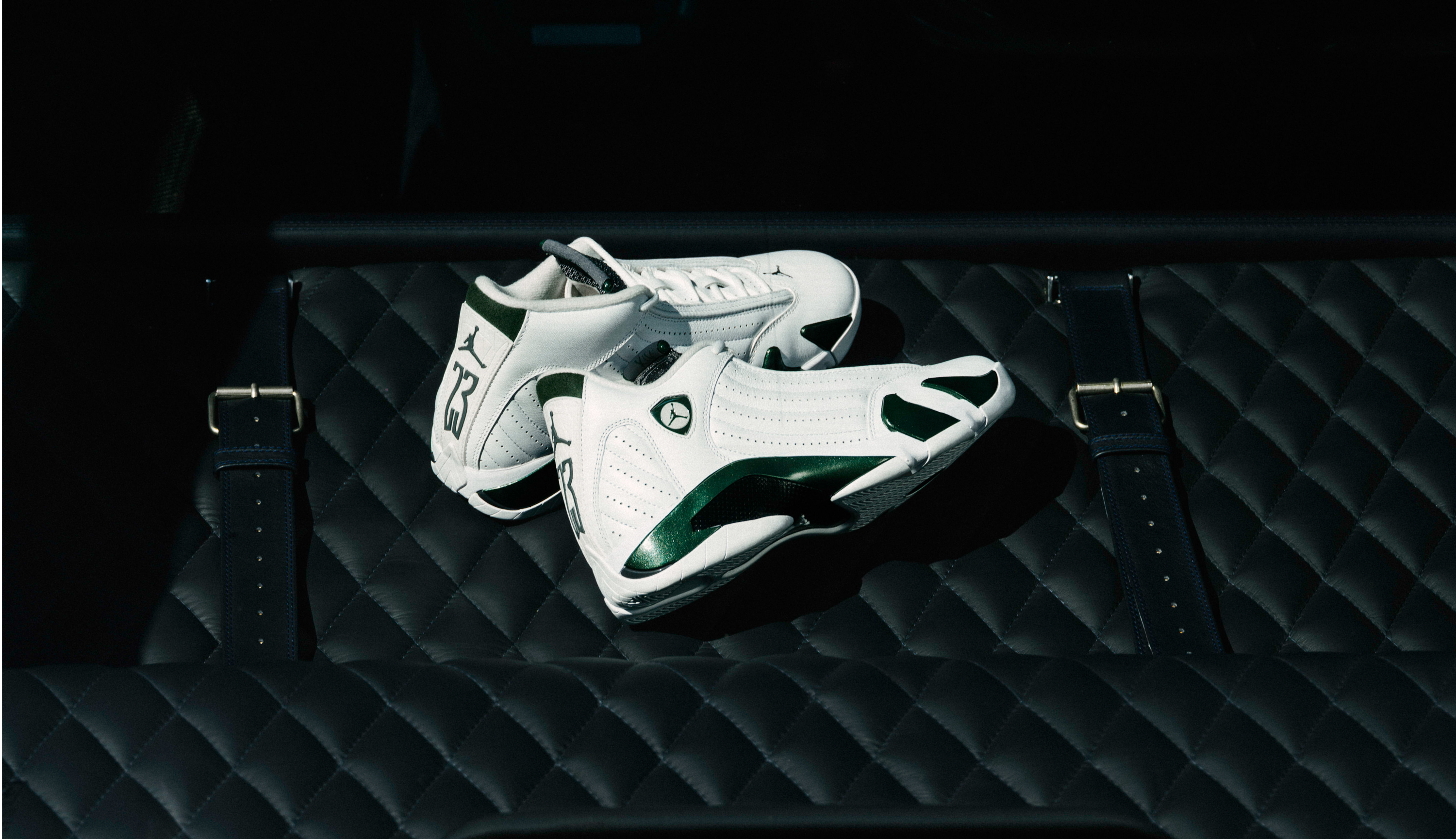 A pair of white athletic shoes on a dark textured surface.