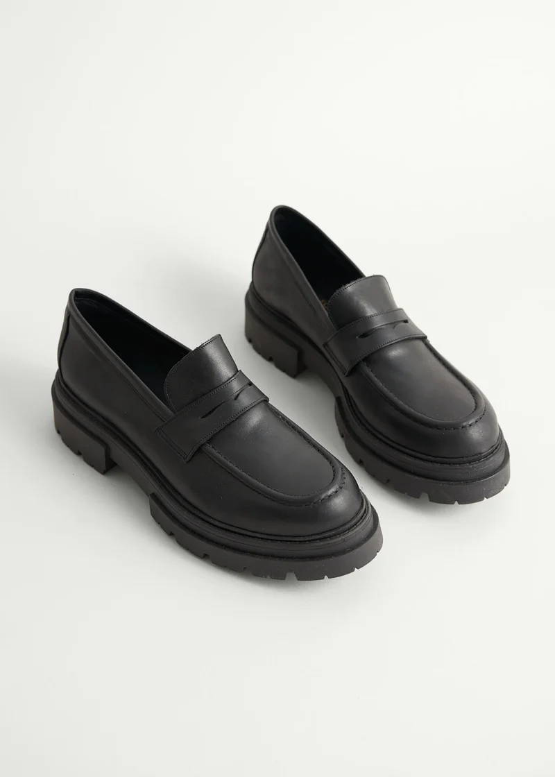 A pair of black chunky leather  loafers