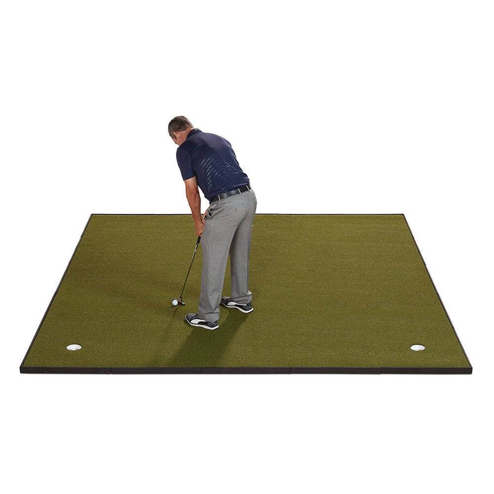 Man putting on a Fiberbuilt putting green