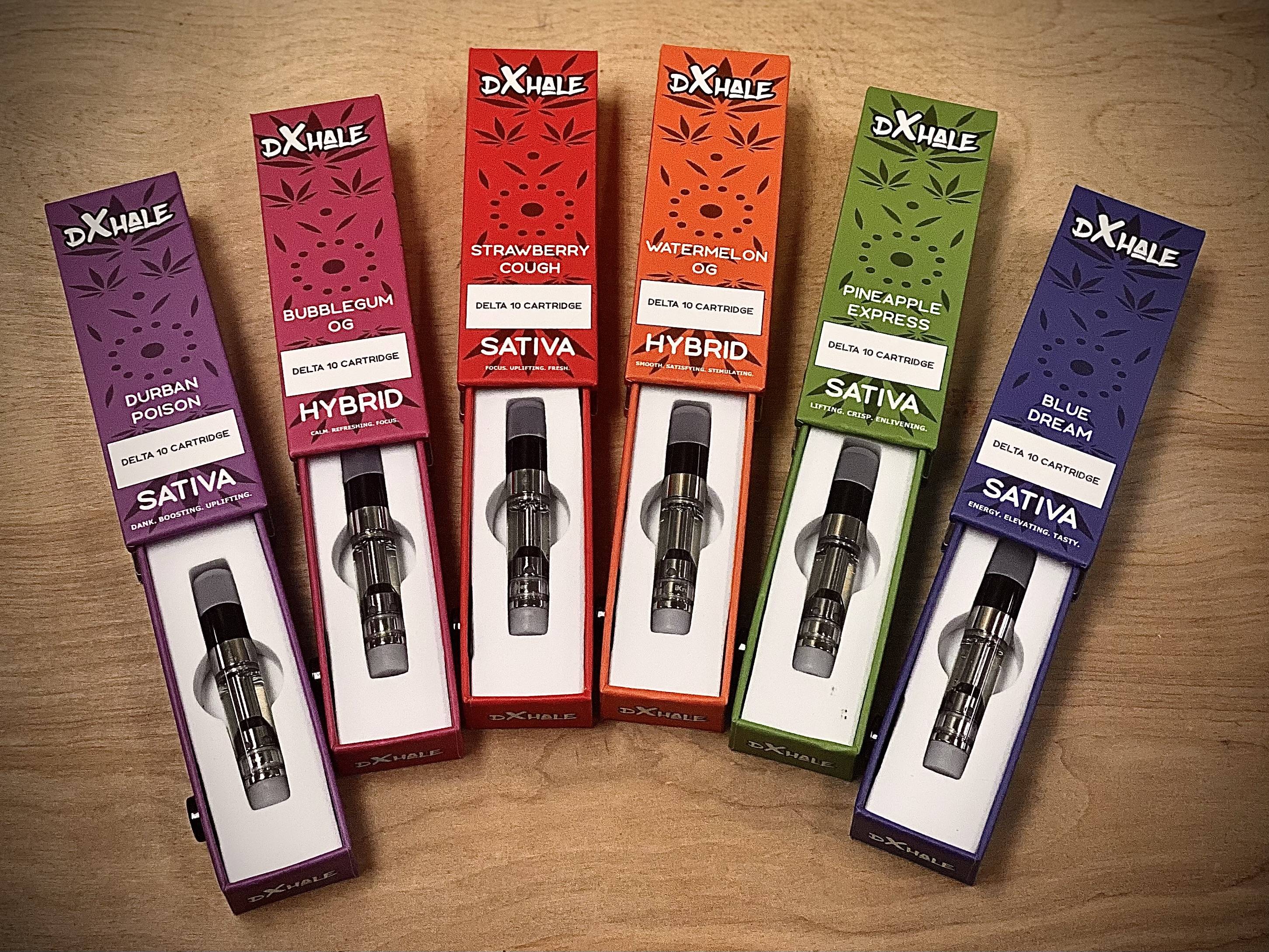 A range of DXHALE delta 10 carts in various flavors on a wooden background.