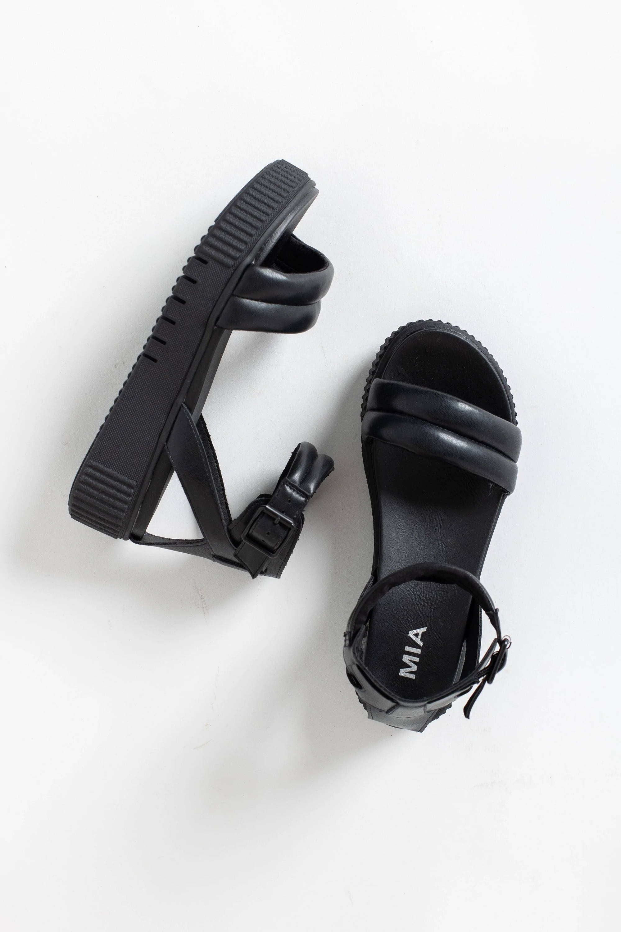 A pair of black leather platform sandals