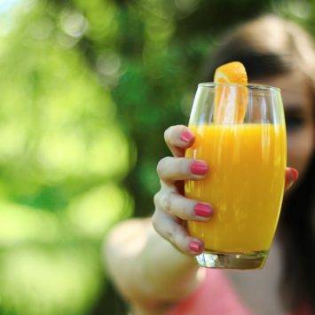 Person Holding Orange Juice