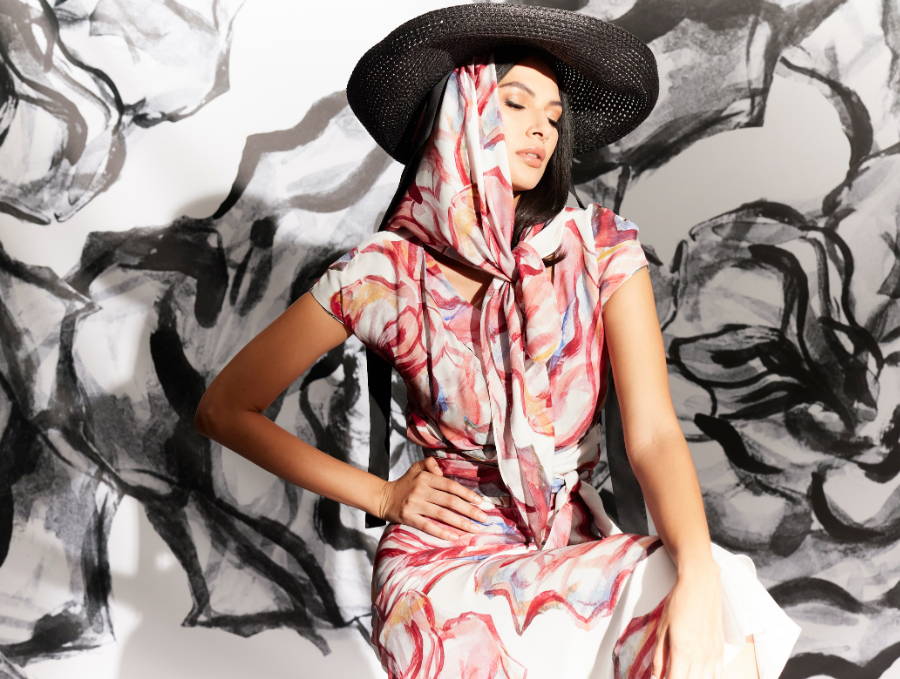 Woman wearing red and white rose printed silk wrap top over matching long silk dress with matching red rose silk scarf and hat