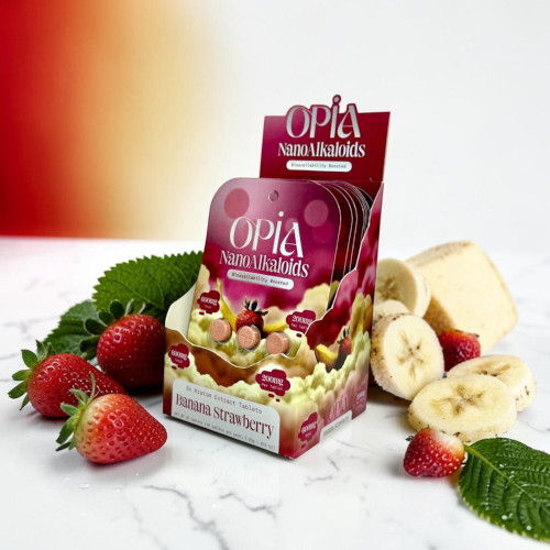Packaged dessert with strawberries, bananas, and mint leaves on a marble surface.