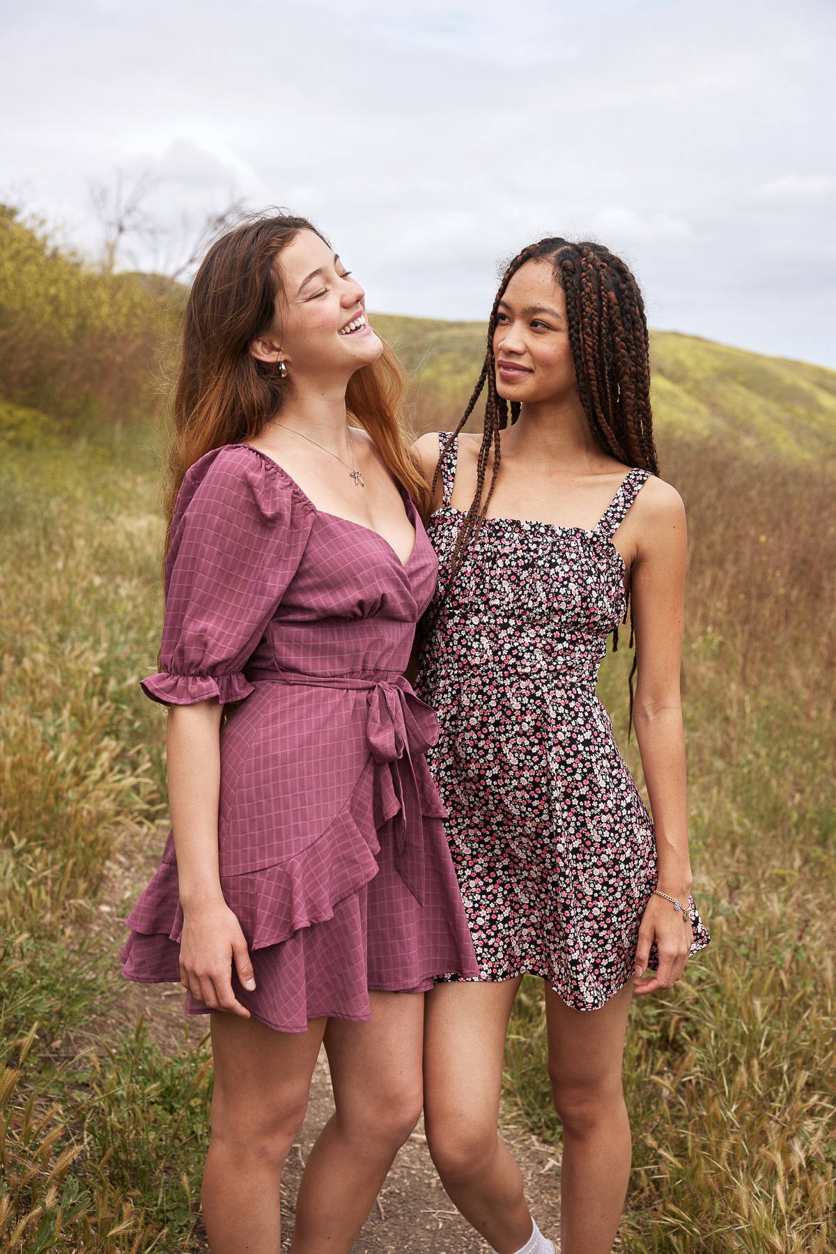 Trixxi sun-kissed summer, girls walking in floral mountain field in pink mauve ruffle dress and ditsy floral mini tank dress.