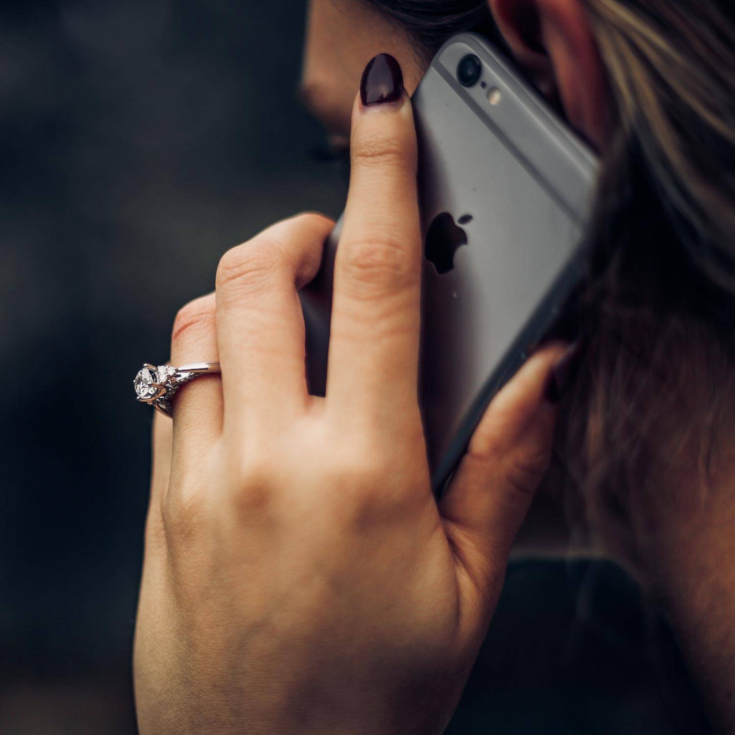 A woman talking on her phone to a loved one.