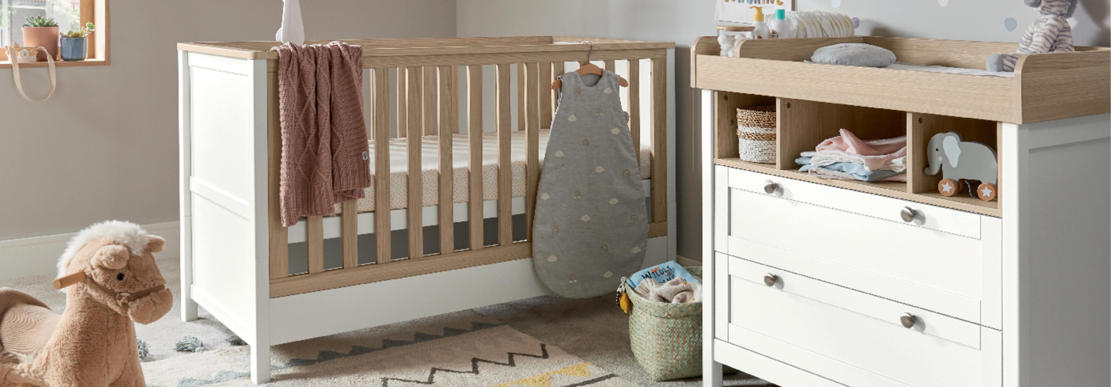 Nursery with a crib, changing table, and soft decor.