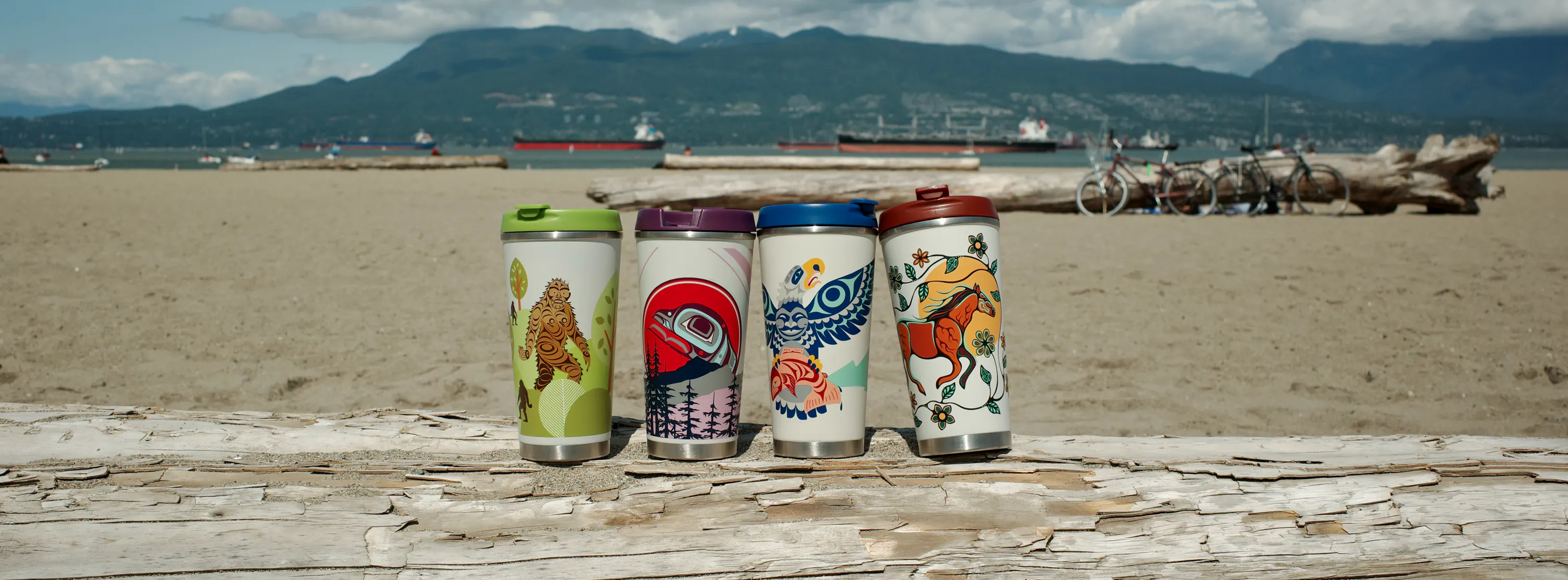 18oz Art Travel Mugs featuring Indigenous artwork on a beach in Vancouver — Native Northwest