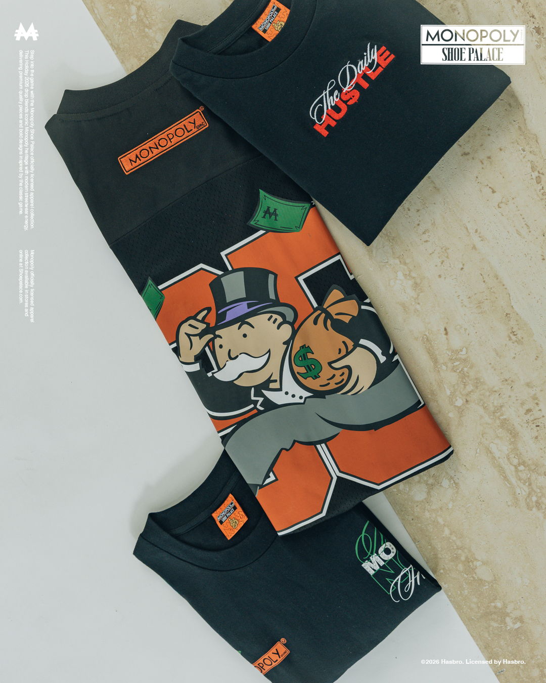 Three t-shirts featuring Monopoly-themed designs on a light surface.