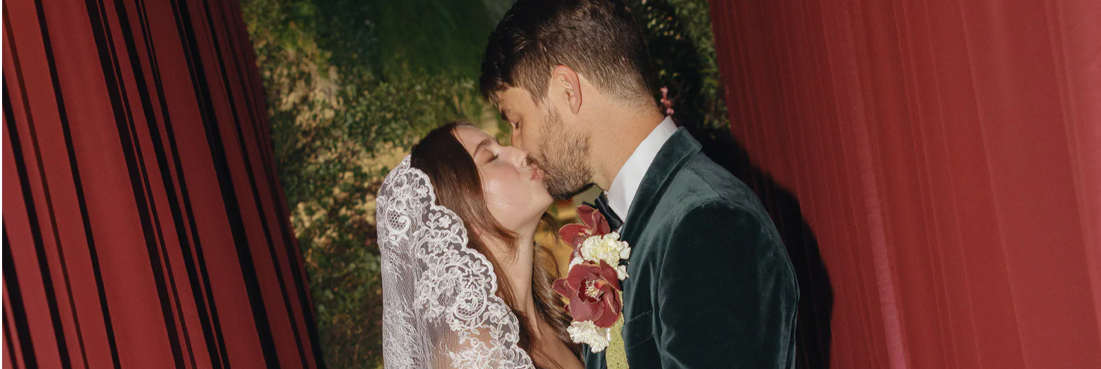 Bride and groom sharing a kiss in an elegant setting.