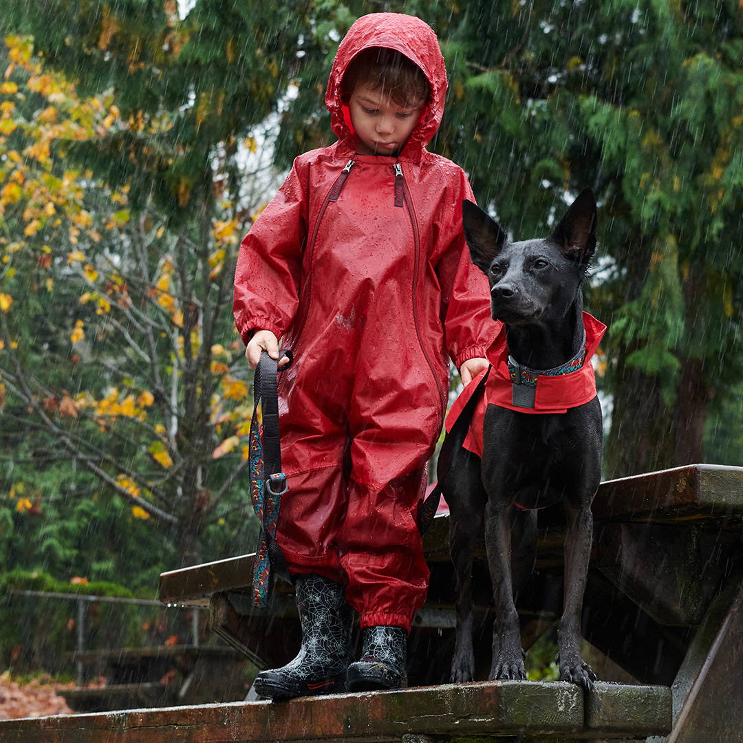 Child with dog in rain