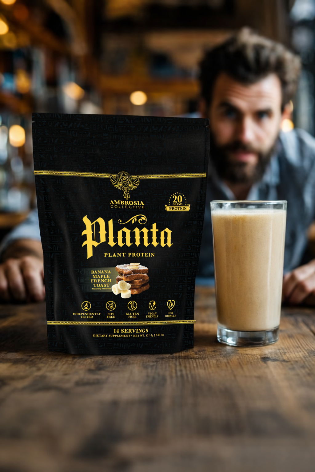A man behind a glass of plant protein drink and a product bag.