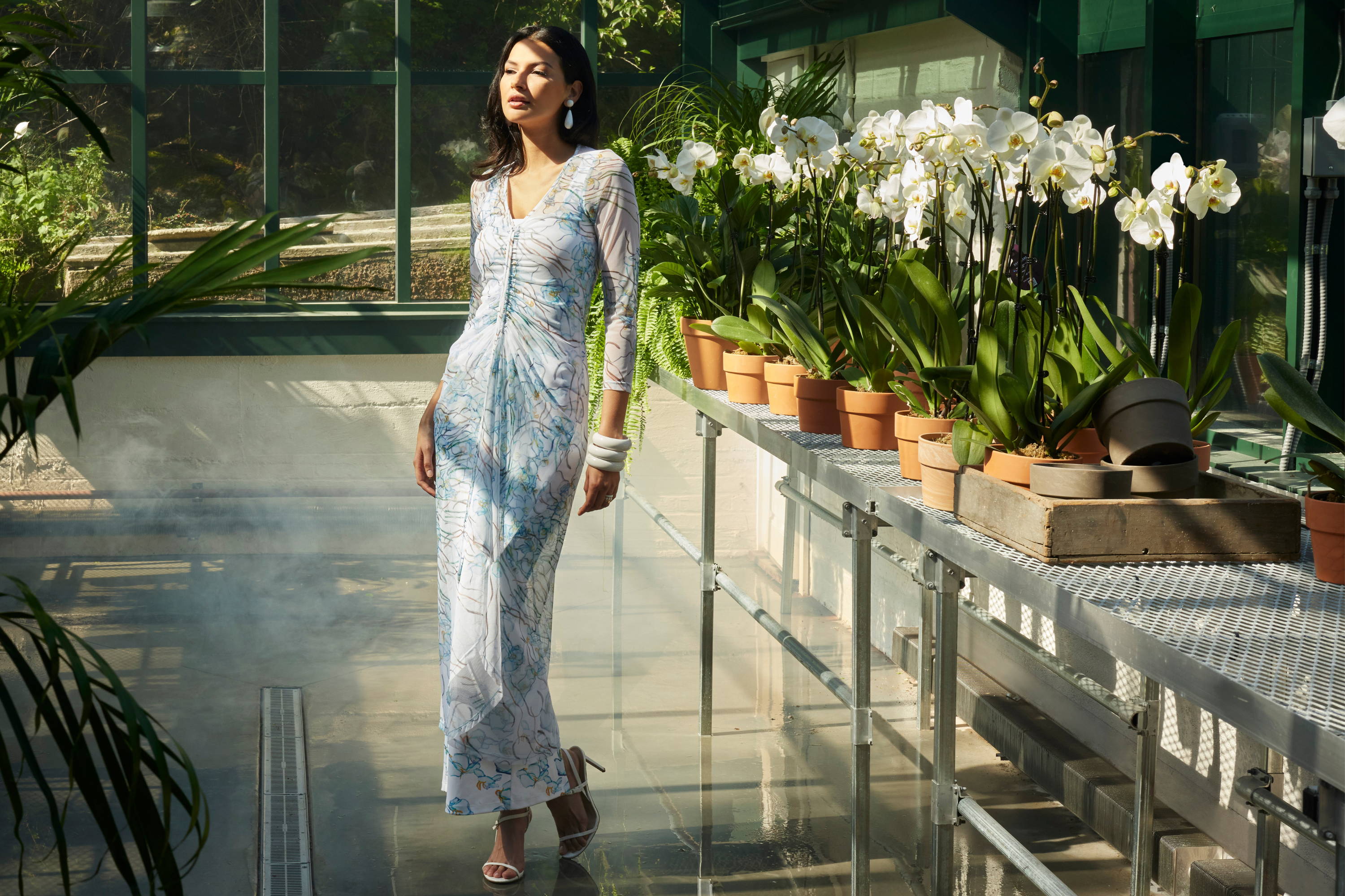 Woman wearing mesh floral topper over a long stretch floral dress by Ala von Auersperg for spring 2024