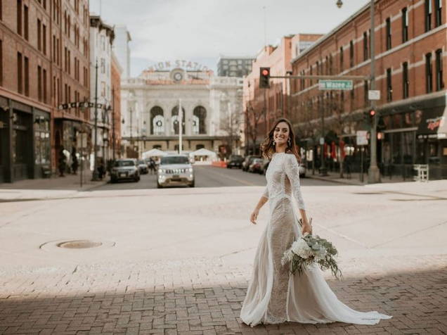Bride wearing the Grace Loves Lace inca gown walking near the Union Station in Denver Colorado