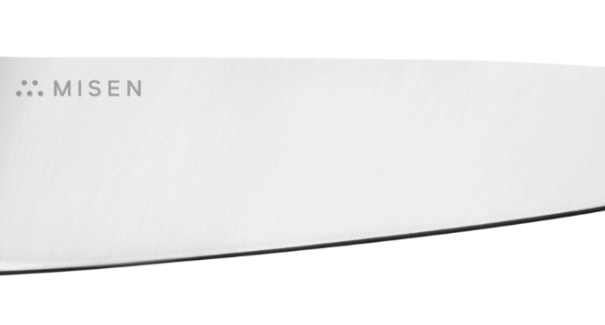 Close view of Misen Utility Knife’s AUS-10 stainless steel blade with Misen logo visible along the spine.