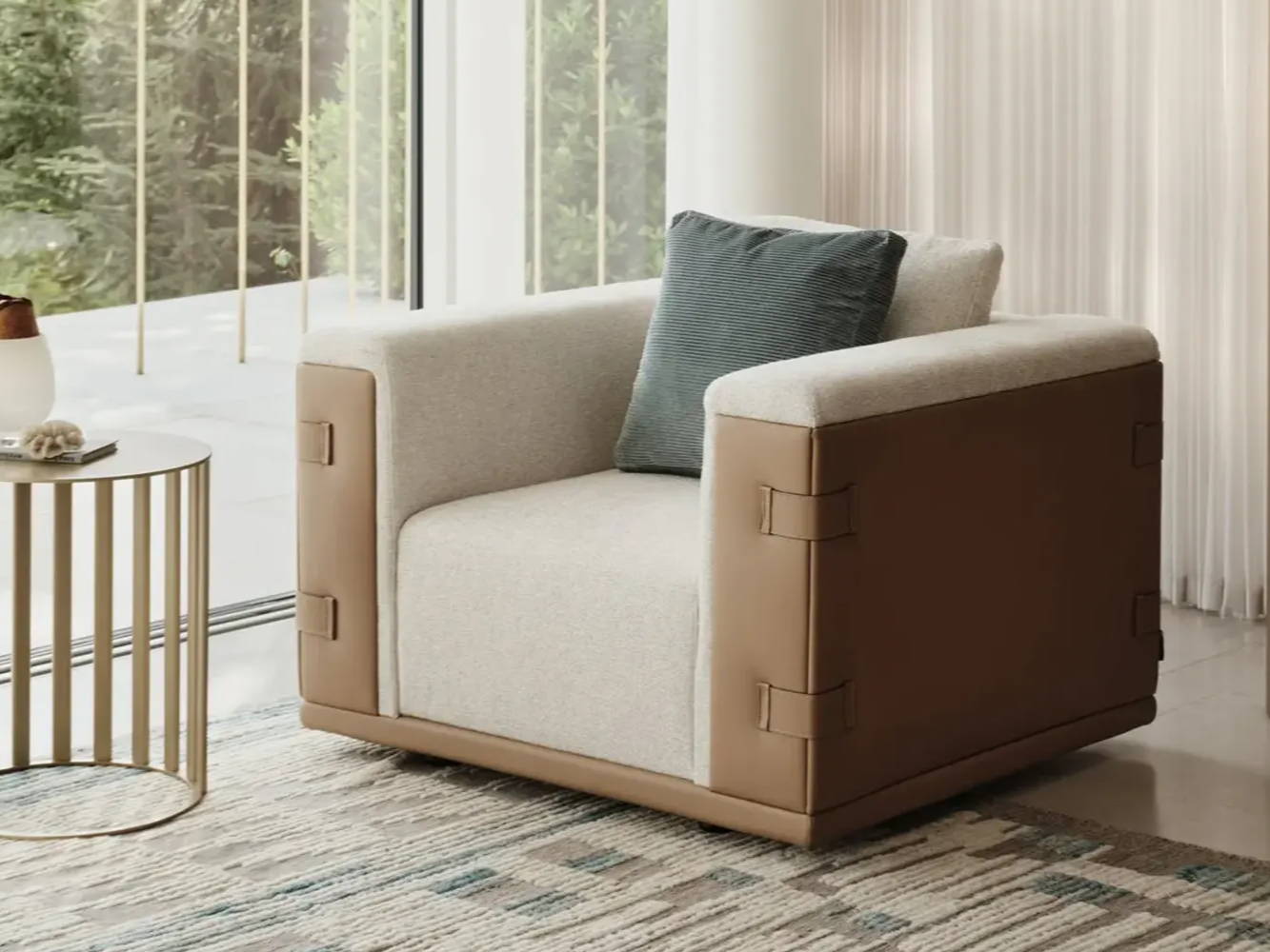Modern armchair with cushion beside a small table and large windows.