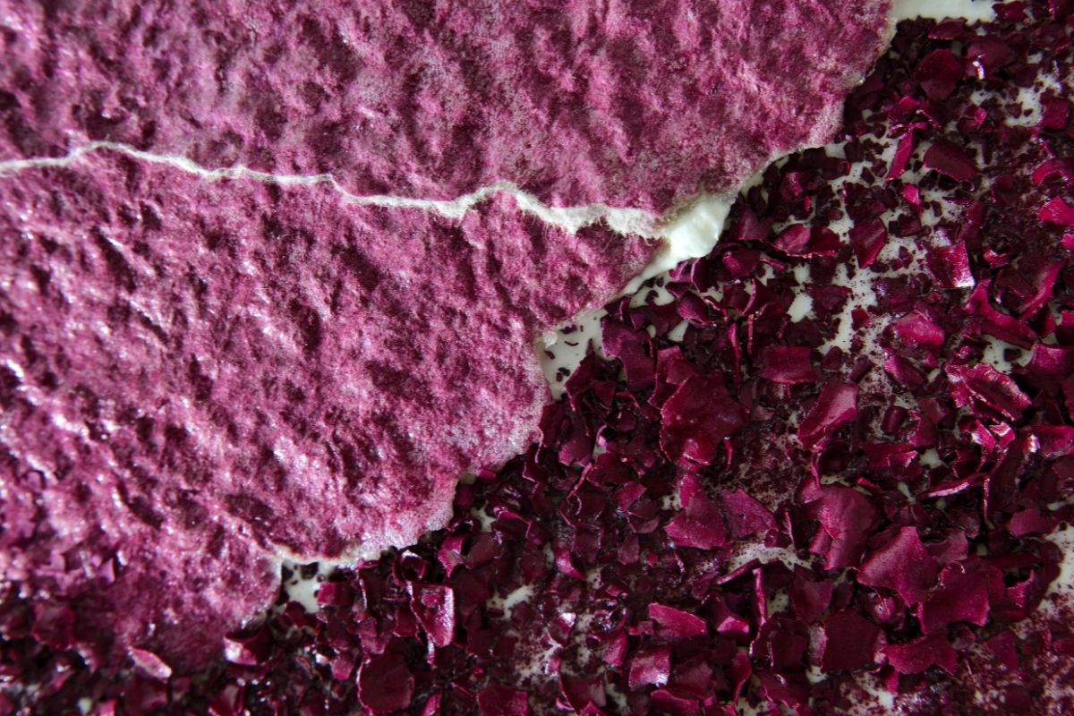 Texture of pink and deep red materials with a cracked surface.