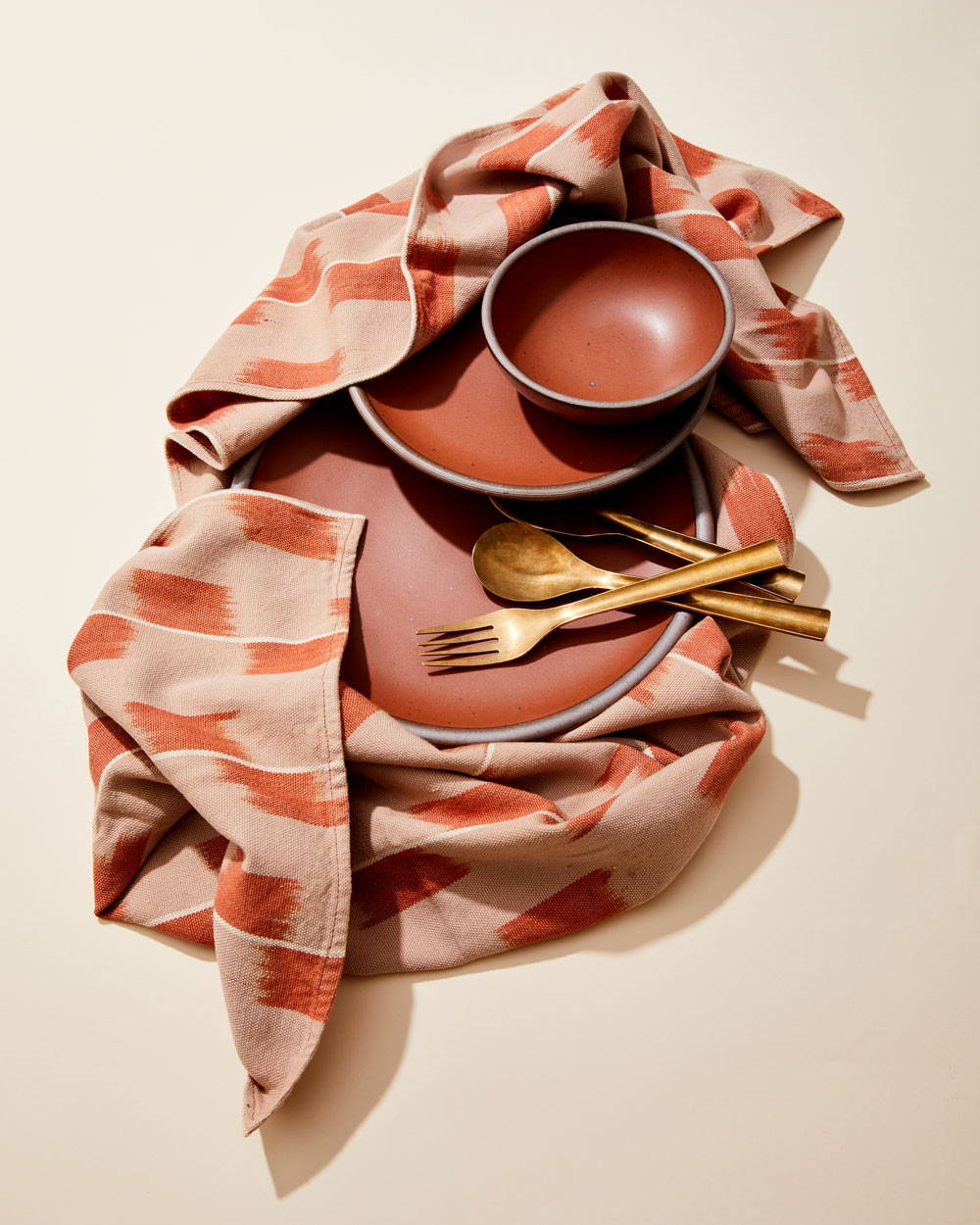 East Fork dishes in Amaro with brass flatware and textiles
