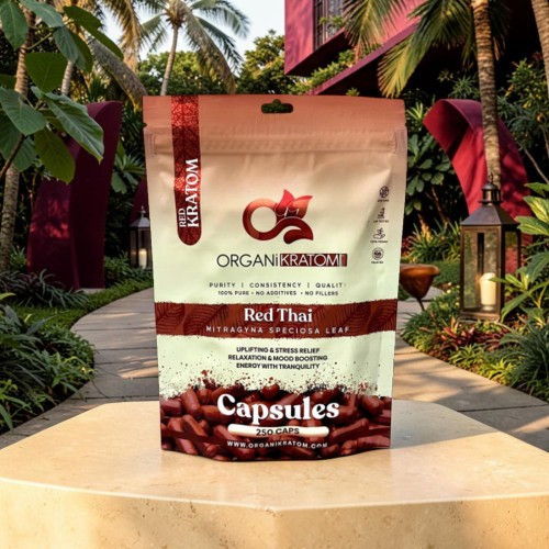Organic Red Thai capsules package in a tropical garden setting.