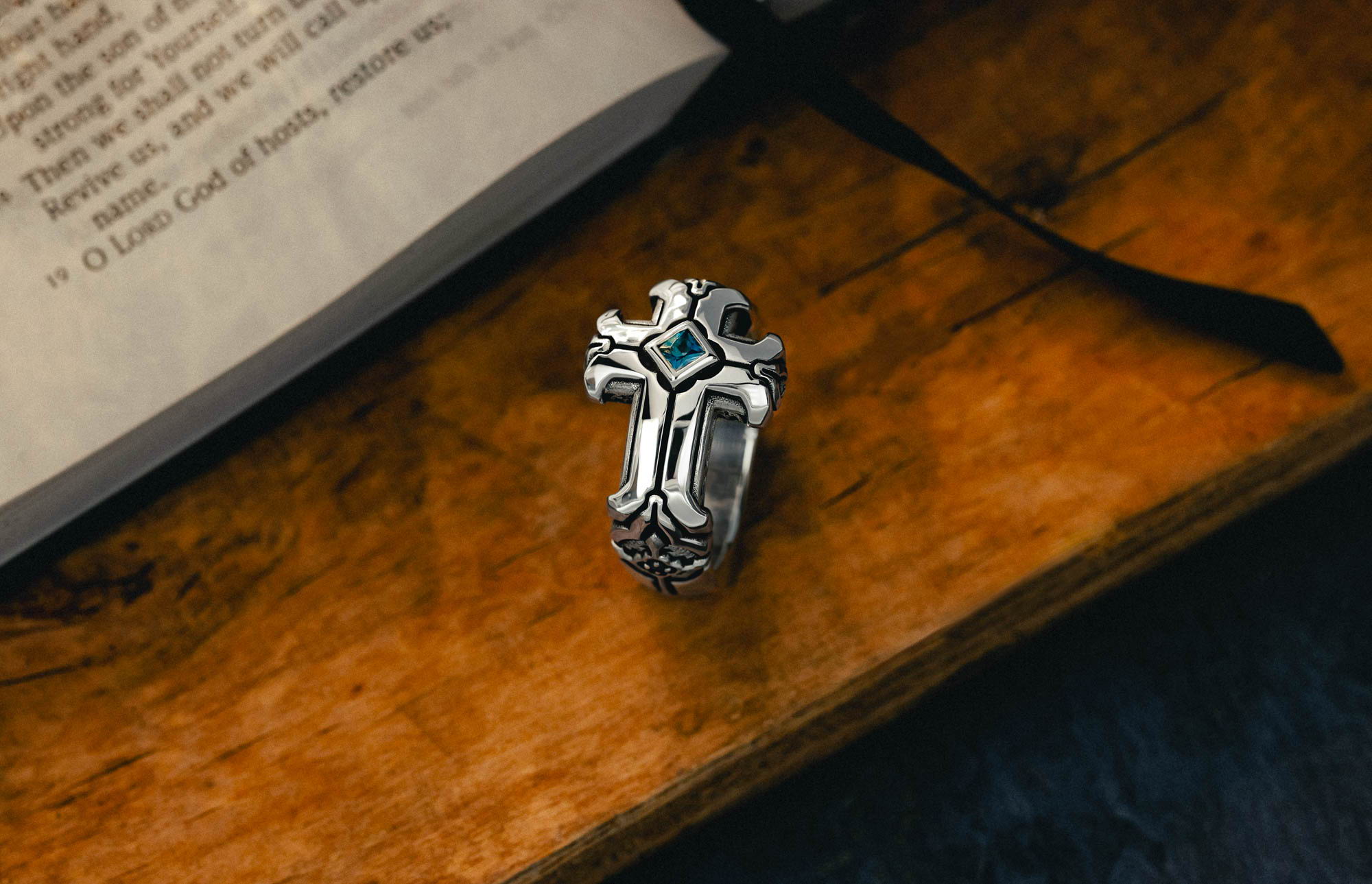 Daily Disciple Ring on a wooden surface beside a bible.