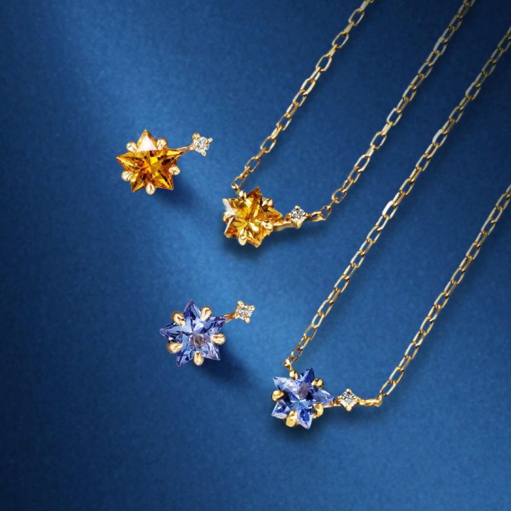 Gold and blue necklaces with star-shaped pendants on a blue background.