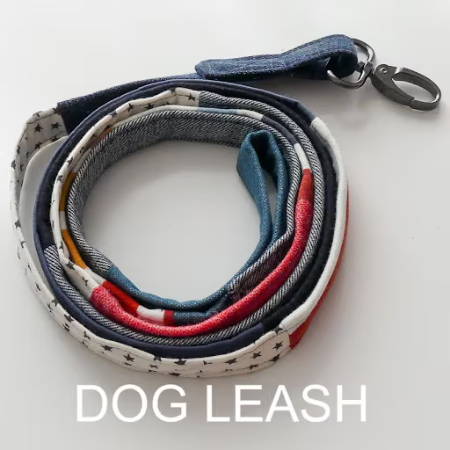 A dog leash sewn from scraps on a white background
