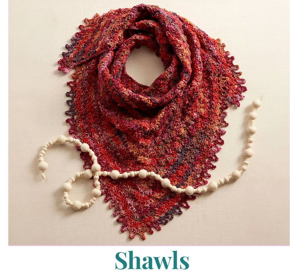 Colorful shawl displayed with decorative beads below it.