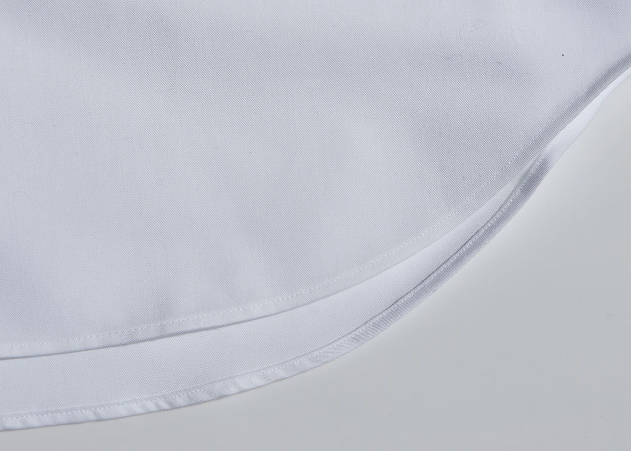 Close-up of a white fabric with a smooth, curved edge.