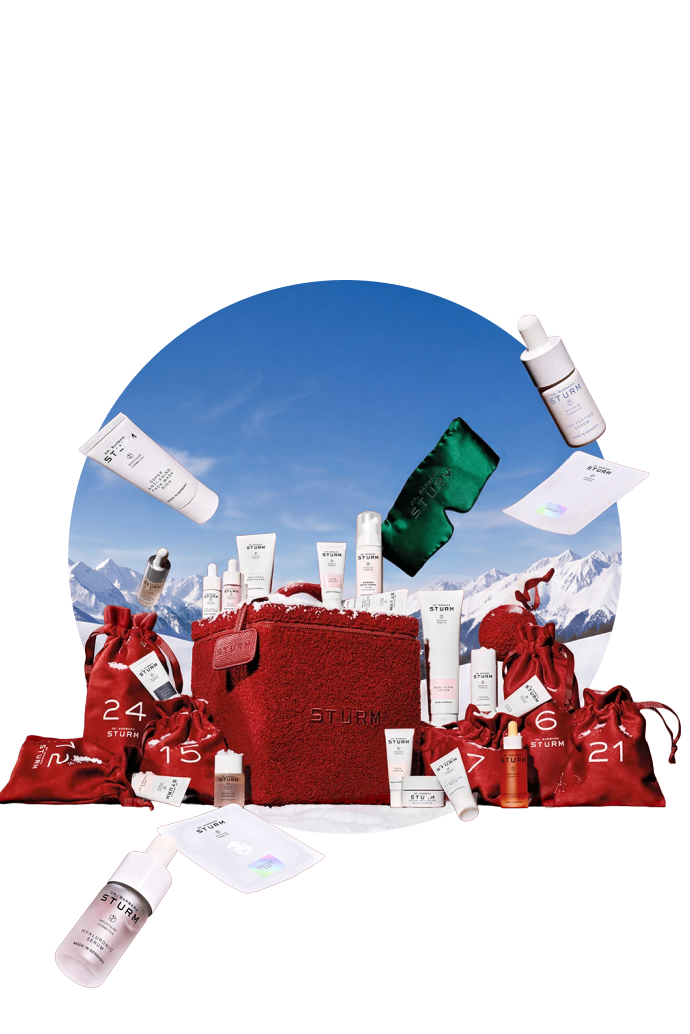 Holiday gift set with skincare products against a snowy mountain backdrop.
