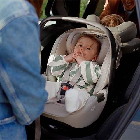 Silver Cross Glide Plus 360 Car Seat with Baby in it.