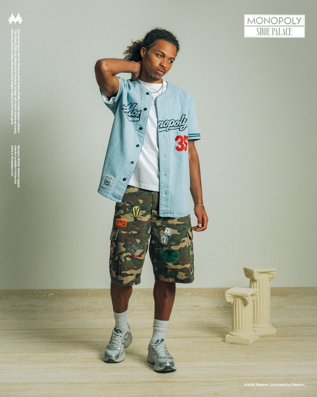A person in casual attire poses in a minimalist setting.