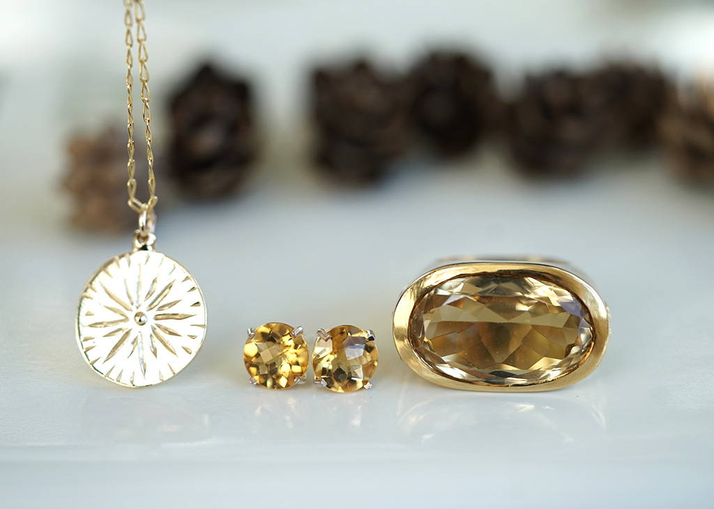 a collection of gold necklace, citrine earrings and a citrine gold ring