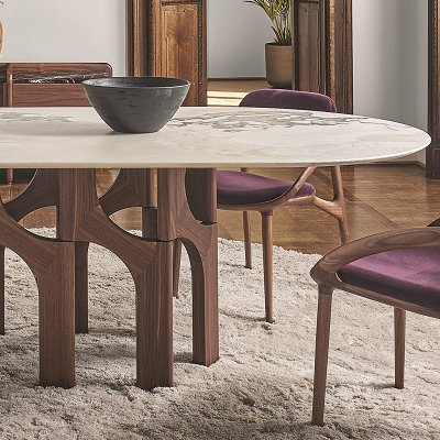 Modern dining table with a marble top and wooden chairs.