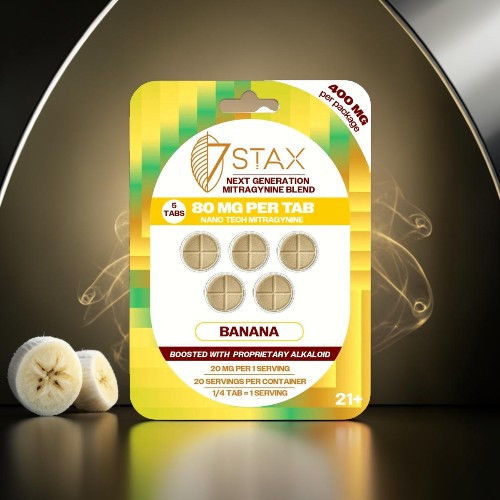 Pack of banana-flavored dietary supplements with tablets displayed on a reflective surface.