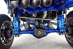 Undercarriage view of Jeff's Ford F250 showing blue suspension, train horns, and aFe POWER differential cover