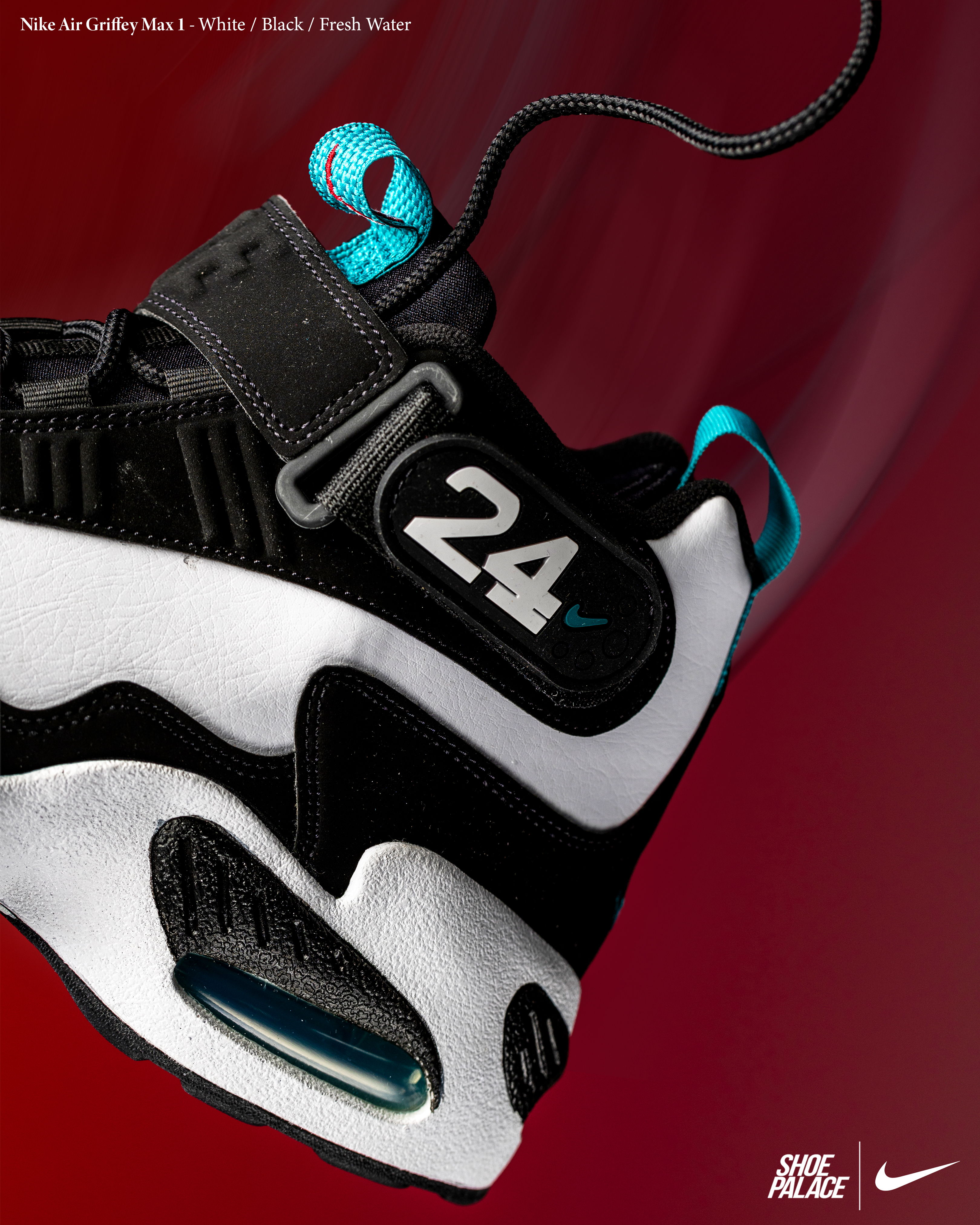 Nike sneaker with black and white design, featuring turquoise accents and number 24.