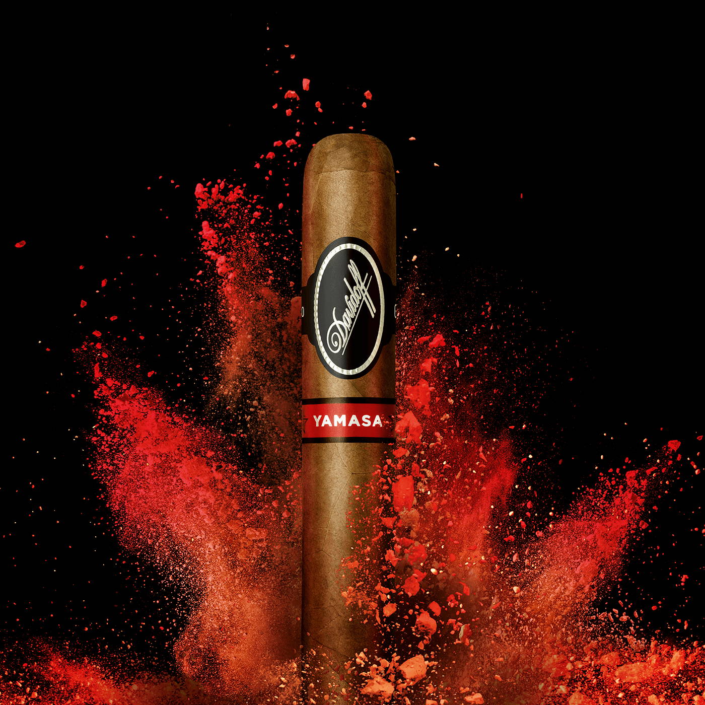 A Davidoff Yamasá cigar standing upright in front of a splash of bright red colour.